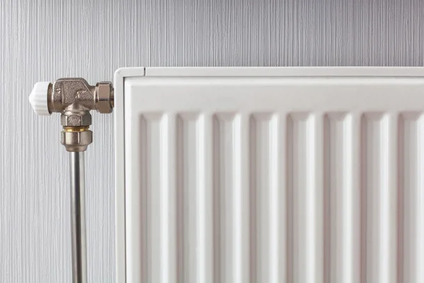 Heating white radiator with adjuster of warming in living room. — Stock Photo, Image