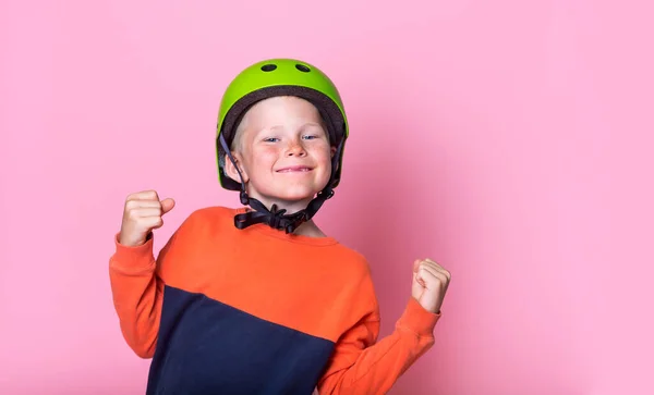 Portrait of proud blond kid in green helmet. happy and excited celebrating victory. School child expressing school boy. big success, power, energy and positive emotions. Celebrates new job joyful — Stock Photo, Image