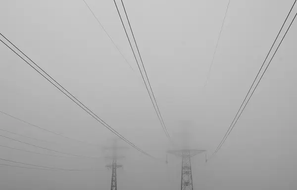 Power lines in the mist — Stock Photo, Image