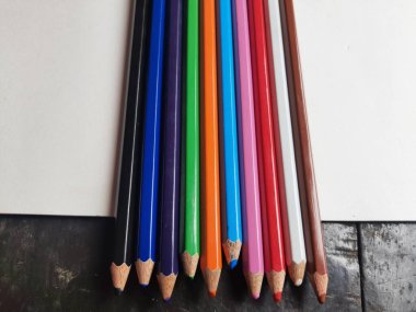 Renkli kalemlerin bir görüntüsü. Beyaz arka planda renkli kalemler. Çerçevenin altındaki renkli kalemler. Beyaz arkaplanda izole edilmiş renkli kalemler. Kapat..