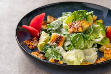 Sezar salatası hardal, parmesan peyniri ve sarımsaklı ekmek ile süslenmiş yeşil marul ve kızarmış ekmek salatasıdır..