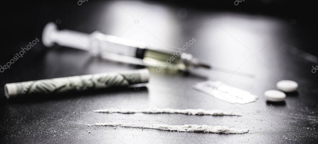 row or row of cocaine, illegal drugs in a dark setting, 