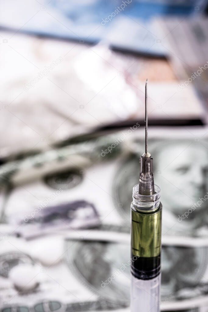 dollar bills and syringe with white powder, heroin and cocina and money. Drug traffickers concept, international drug sales