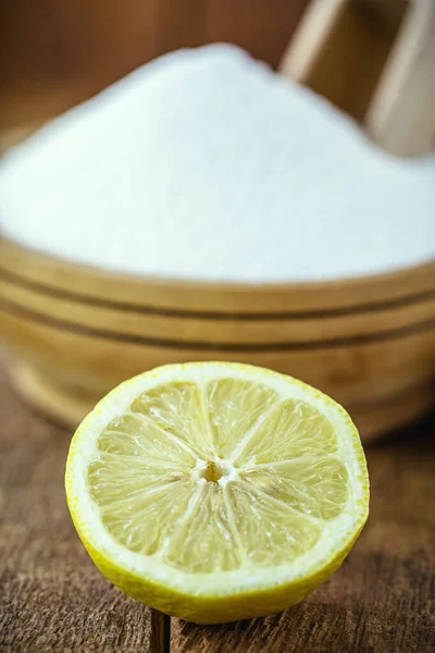 bowl with baking soda and citrus fruits like lemon or orange around. Home remedy against stomach acid, anti acid