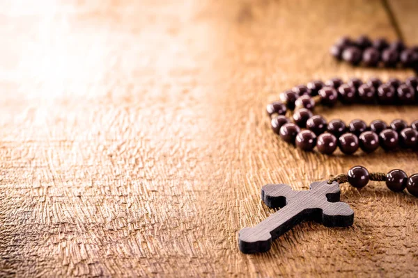 wooden rosary radiated by divine light, concept of faith and spirituality, copy space