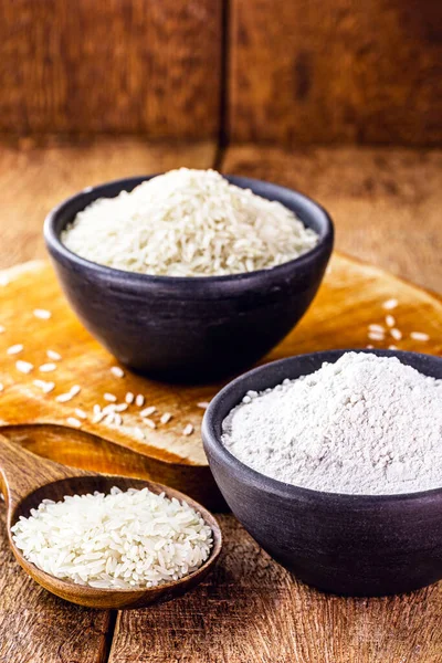 fine and ground rice flour, in handmade clay pot with rustic wooden spoon