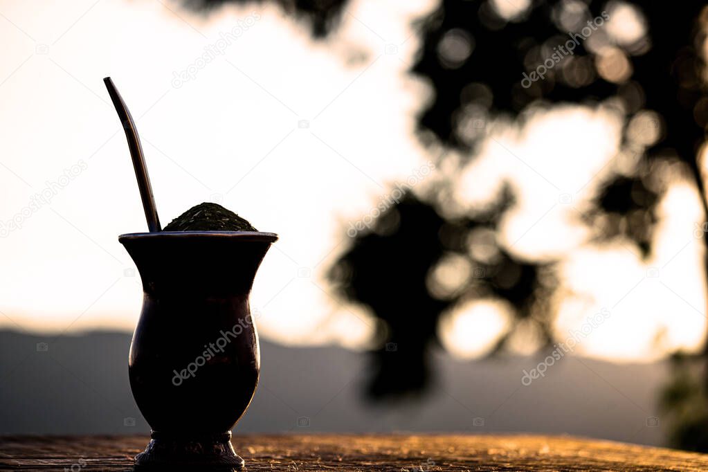 Chimarrao, a traditional Brazilian yerba mate tea. Typical South American drink with Serra Gacha in the background