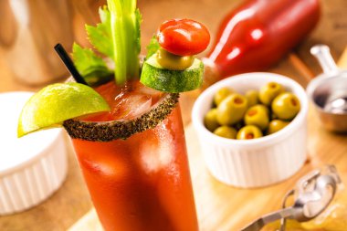 Canadian Caesar drink, typical Canadian drink, with hot sauce, celery, lemon, vodka and ice clipart