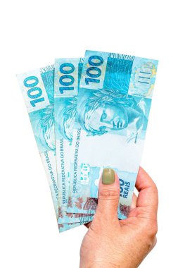 Kadın eli 100 reais banknot, emeklilik konsepti veya devlet yardımı tutuyor