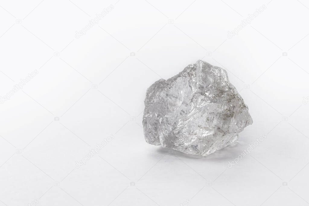 large rough diamond stone on isolated white background.
