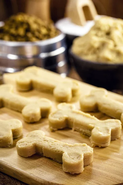 dog food dough in the shape of a bone, raw dough to be cooked at home