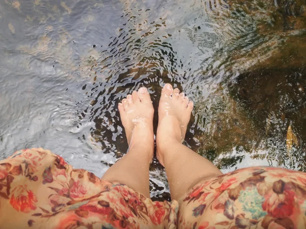 Top view of women leg and feet dip in crystalline stream — Stock Photo, Image