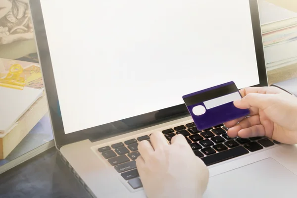 People hands hold credit or debit card infront of notebook for i — Stock Photo, Image