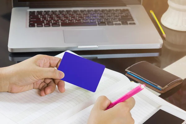 Hand take blank card and pen writing down on empty note book or — Stock Photo, Image