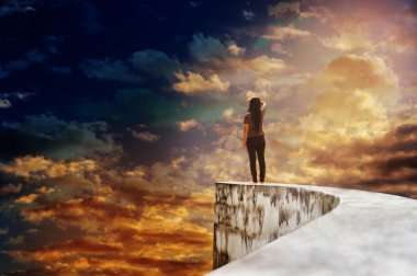 Women on dead end way high up on vast sky clipart