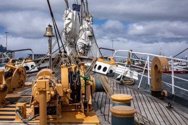 REYKJAVIK, ICELAND - June 11, 2021: Front deck, bow, anchor winches and folded sails of American coastguard tallship Eagle, visiting Reykjavik Harbour. Sunny day, blue sky. 
