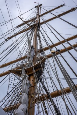 REYKJAVIK, ICELAND - June 11, 2021:Main mast, crow's nest, sails, yards and rigging ropes on the deck of US coastguard tallship Eagle visiting Reykjavik Harbour. 