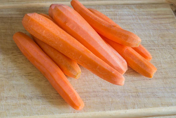 A lot of carrots on the table — Stock Photo, Image