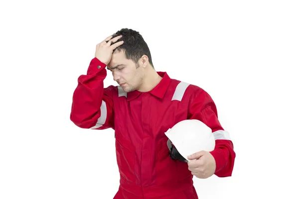 Depresyon alnına el ile çalışan adam. Üniformalı güvenlik kask - izole tutarak başını elleri ile şok erkek inşaat işçisi.