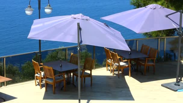 Umbrella and chair, sea background. — Stock Video