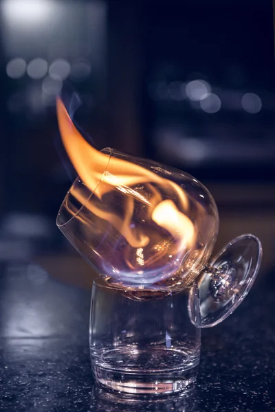 Glass with burning alcohol. Image of two glasses of burning emerald absinthe. Glass of tequila and flames — Stock Photo, Image