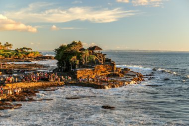 Tanah Lot temple in the sunset extending into the ocean in Bali