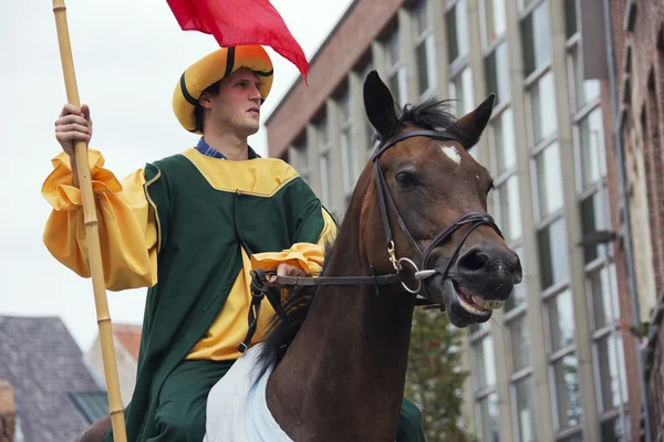 Rider in medieval clothes on a laughing horse