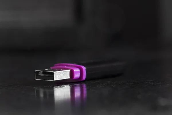 USB flash drive on a black office desk