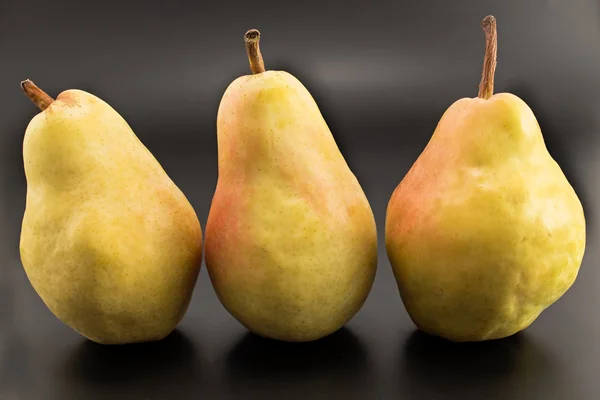 Three pears isolated on the black — Stock Photo, Image