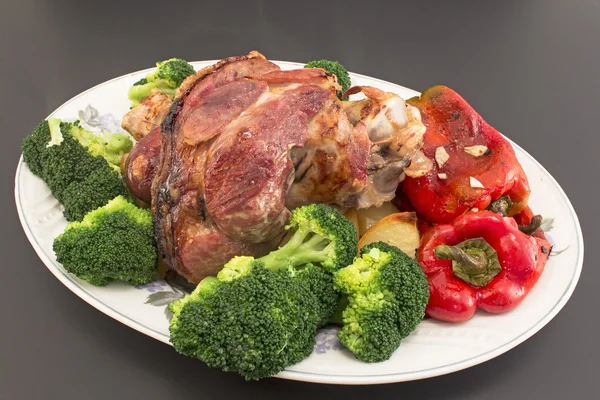 Baked pork knuckle with vegetables — Stock Photo, Image