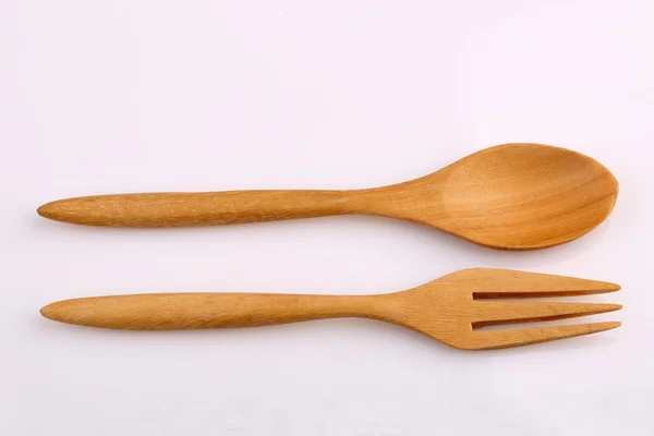 Ahşap çatal ve tahta kaşık Teak beyaz arkasında izole tarafından yapılan