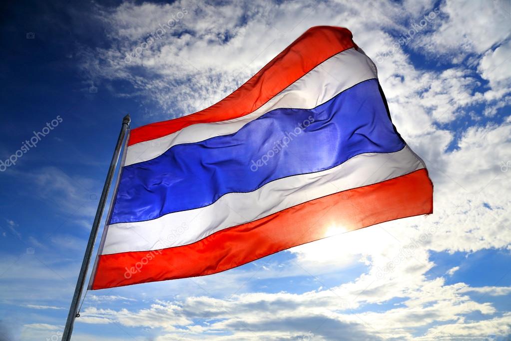 Thailand flag waving in the wind with beautiful blue sky and sunlight