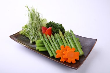 Asparagus Batayaki on clay dish isolated on white background, As