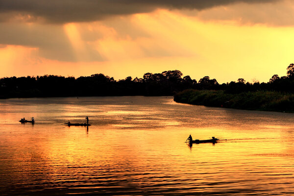 Local fishing boat in dusk with twilight at Chao Phraya River, T