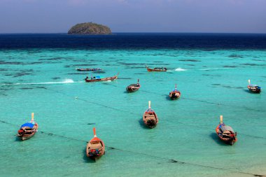 Thai local fishing boats on seaside at Lipe island beach of the  clipart