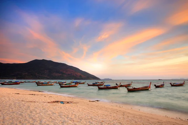 Beautiful Sunset and local fishing boats on seaside at Lipe isla