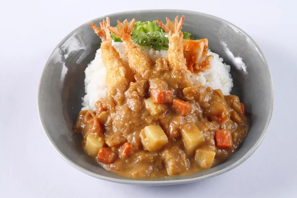 Japanese curry rice with shrimp tempura isolated on white backgr