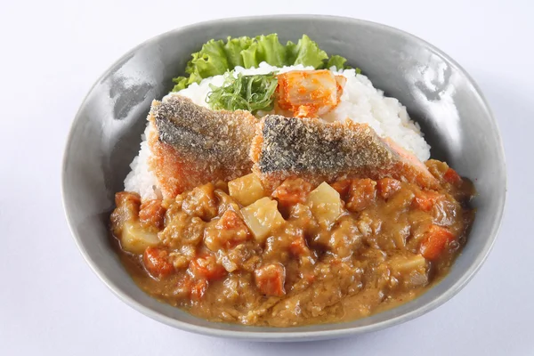 Japanese curry rice with deep fried fish (Sea Bass) isolated on 