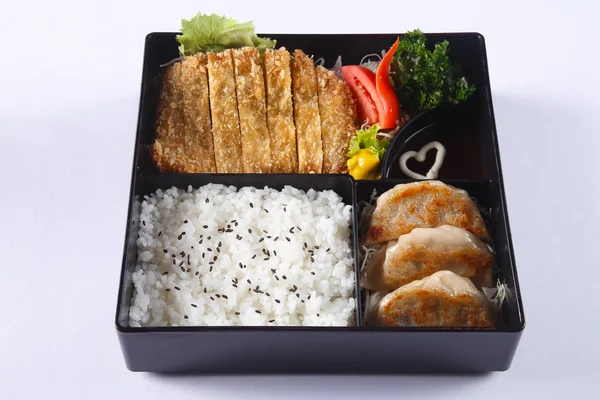 Bento set of Deep fried pork (Tonkatsu), Gyoza, Japanese rice, i Stock Kép