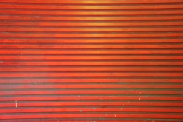 Régi narancssárga fém ajtó redőny textúra háttér Jogdíjmentes Stock Fotók