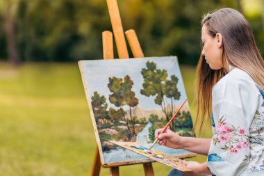 Dışarıda tuvalde acı çeken bir kadın sırtüstü oturuyor.