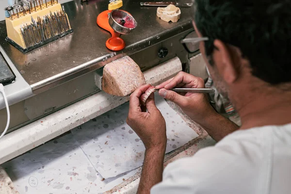 Odontotecnico che scolpisce una protesi dentale — Foto Stock