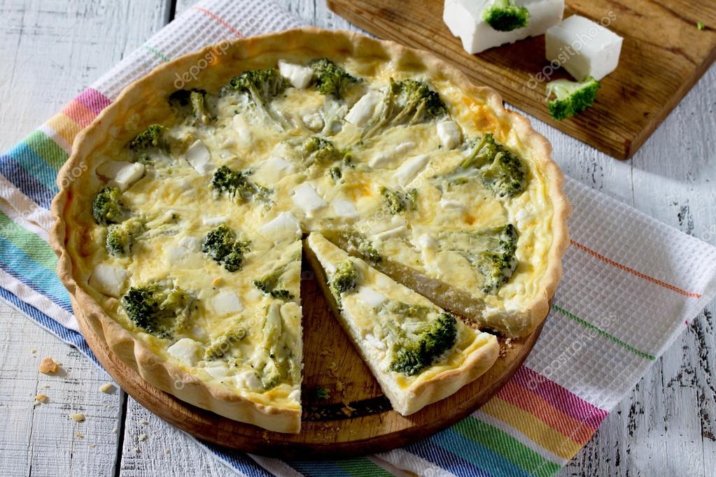 Open pie quiche Lauren with broccoli on a white wooden table Stock ...