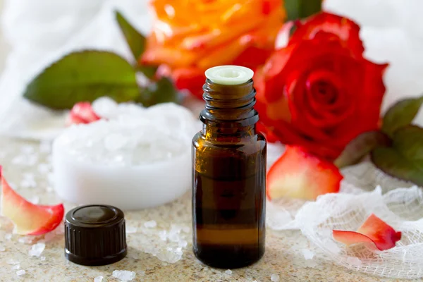 Essential oil bottle of aromatherapy on a brown stone background — Stock Photo, Image