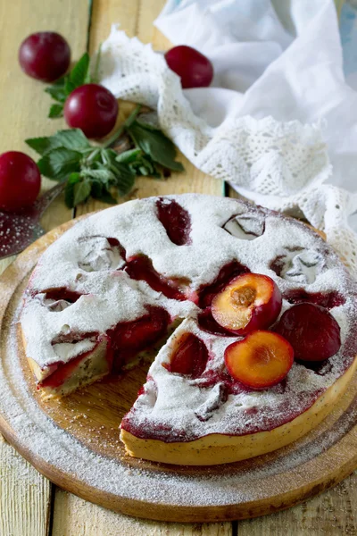 Plum cake sponge cake with poppy seeds on a wooden table, select