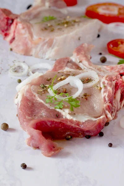 Delicioso pedazo de carne fresca en el hueso con hierbas aromáticas y —  Fotos de Stock