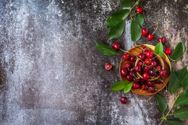 Taze taze organik dut. Koyu taştan bir masanın üstünde kırmızı kiraz. Üst görünüm düz arkaplan. Boşluğu kopyala.