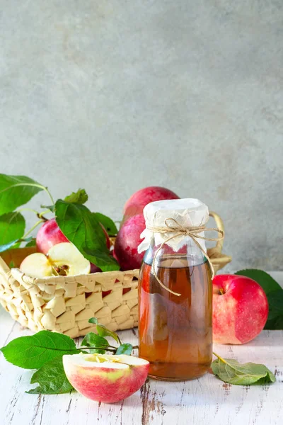 Healthy organic food. Apple vinegar, a bottle of apple cider vinegar on a rustic table. Copy space.