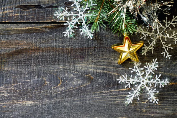 Golden Christmas decorations and spruce branches on a wooden tab — Stock Fotó