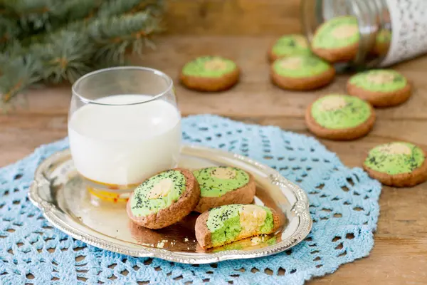 Cookie kiwi and glass of milk on a napkin knitted — Stock Photo, Image